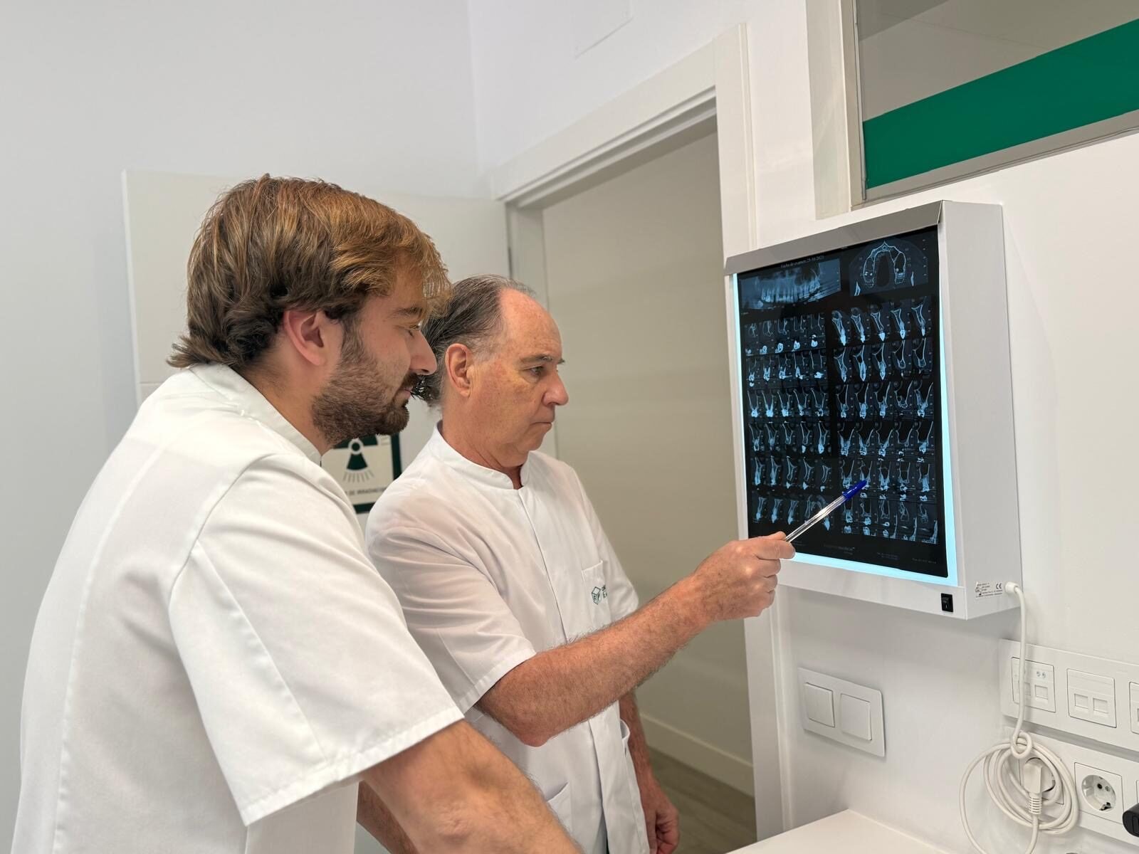 Dr. de la Peña con asociado analizando radiografías